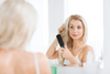 A woman getting her hair styled.